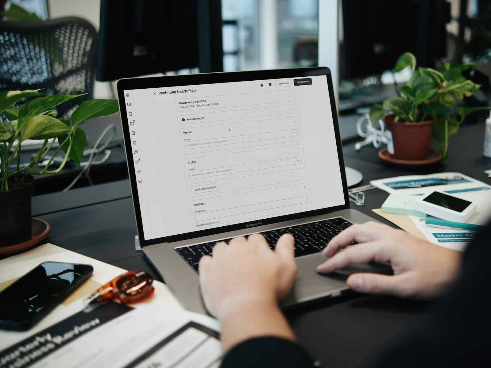 Business owner reviewing a digital invoice at a laptop